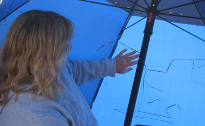 Noreen Grice touches constellations in the portable touchable planetarium dome