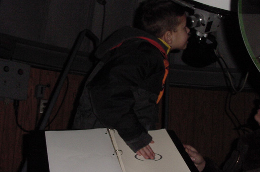 A Visitor touches picture of Saturn