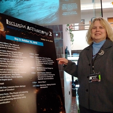 Noreen Pointing at Sign